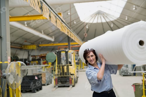 Preview: Worker Carrying Ream Of Wrapping In Manufacturing Plant