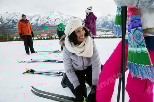 Preview: Family Preparing To Ski In Snowy Field