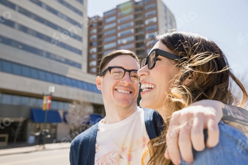 Preview: Couple Laughing On Sunny Urban Street