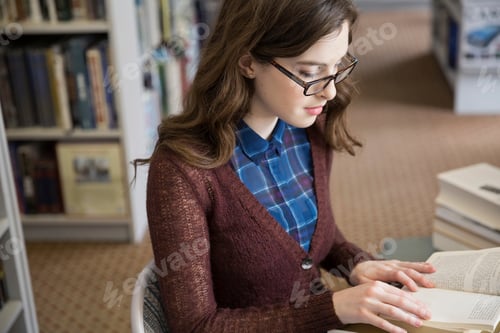 Preview: Girl In Eyeglasses Reading Book In Bookstore