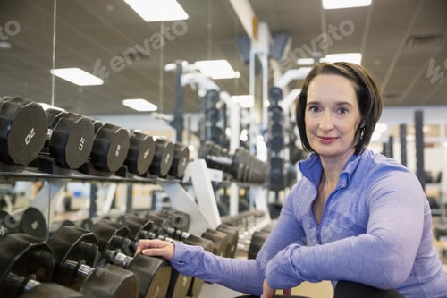 Preview: Portrait Of Woman Weight Lifting At Gym