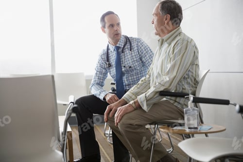 Preview: Doctor Talking With Senior Patient In Waiting Room