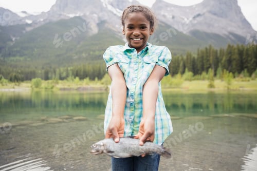 Preview: Portrait Of Proud Girl Holding Fish At Lake