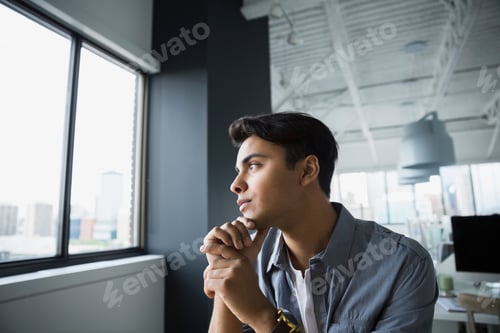 Preview: Pensive Businessman Looking Out Office Window