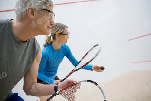 Preview: Couple In Goggles Playing Squash On Court