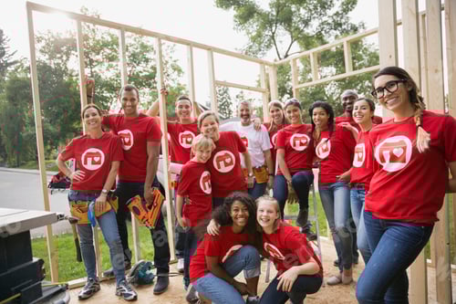 Preview: Portrait Of Smiling Volunteers At Construction Frame