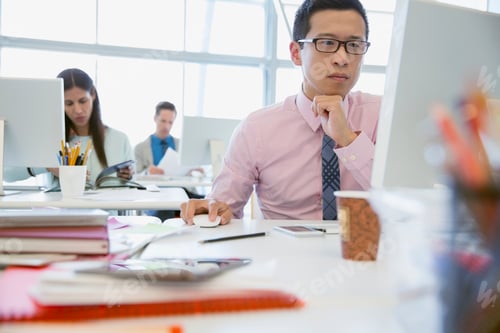 Preview: Serious Businessman Working At Computer In Office