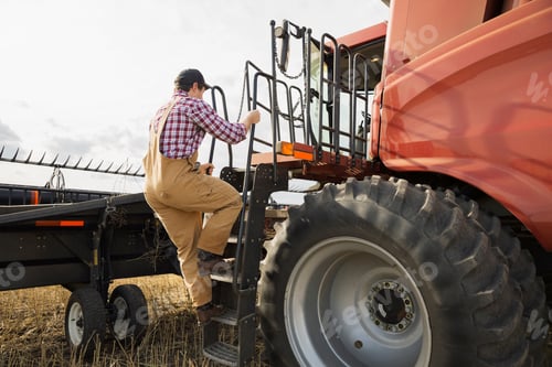 Preview: Farmer Climbing Into Combine Harvester