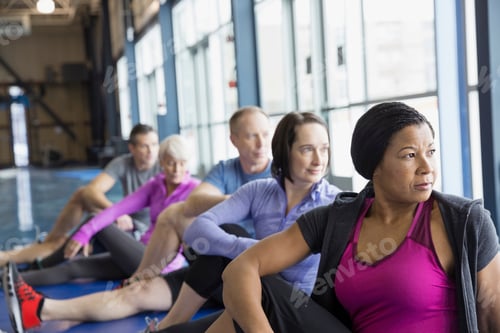 Preview: People Stretching In Exercise Class At Gym