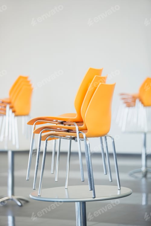 Preview: Stacked Chairs On Table In Cafeteria