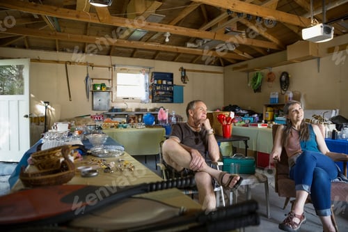 Preview: Couple Sitting At Garage Sale
