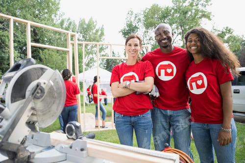 Preview: Volunteers At Table Saw Near Construction Frame