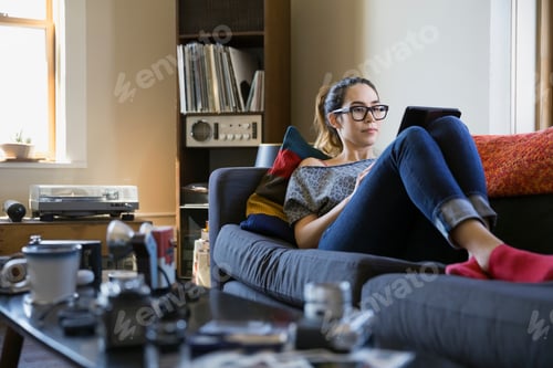 Preview: Woman Using Digital Tablet On Sofa