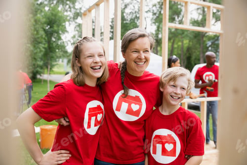 Preview: Portrait Of Smiling Volunteers At Construction Frame
