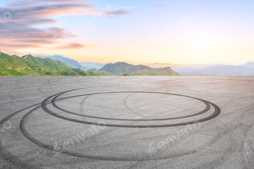 Preview: Empty Asphalt Square Car Tire Brakes And Mountain Scenery At Sunrise