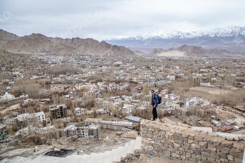 Preview: Traveler Man Standing On Leh Ladakh City View From Shanti Stupa. Beautiful Amazing Village In The