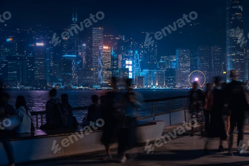 Preview: Hong Kong Cityscape At Night. Tourists Walking On The Waterfront