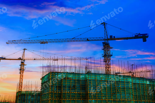Preview: Tower Crane And Building Construction Site Silhouette At Sunrise.