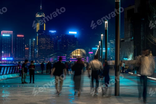 Preview: Hong Kong Cityscape At Night. Tourists Walking On The Waterfront
