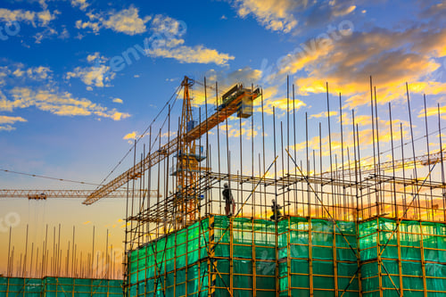 Preview: Tower Crane And Building Construction Site Silhouette At Sunrise.