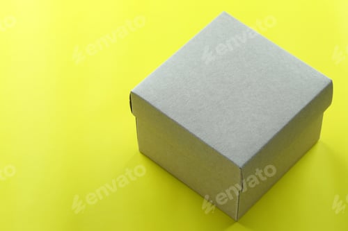 Preview: Brown Paper Box Rests On A Yellow Paper Floor And Have Copy Space For Design In Your Christmas Work