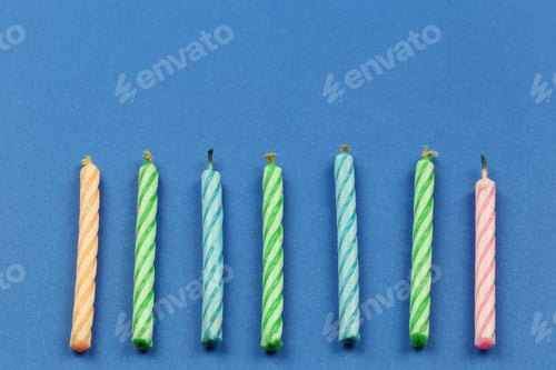 Preview: Small Candles On Blue Paper Background And Have Copy Space For Design Your Work Christmas Concept.