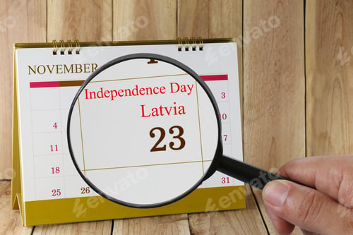 Preview: Magnifying Glass In Hand On Calendar You Can Look Independence Day Of Latvia 23 November,Concept Of