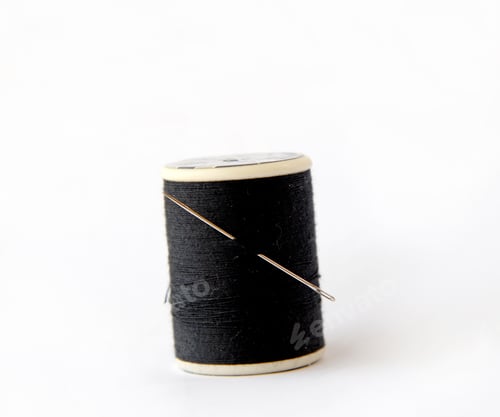 Preview: Spool Of Thread With A Needle Closeup On White Background