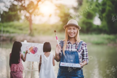 Preview: Mother And Daughter Drawing Picture Together In The Park