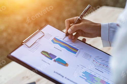 Preview: Hands Of Businessman Working On Laptop Computer With Data Charts