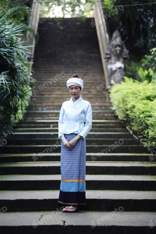 Preview: Portrait Of Thai Young Woman With Traditional Thai Dress In Thai Temple With Tree And Sunrise