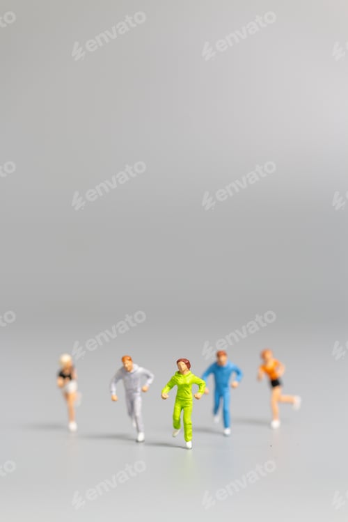 Preview: Miniature People Running On Gray Background And Free Space For Text