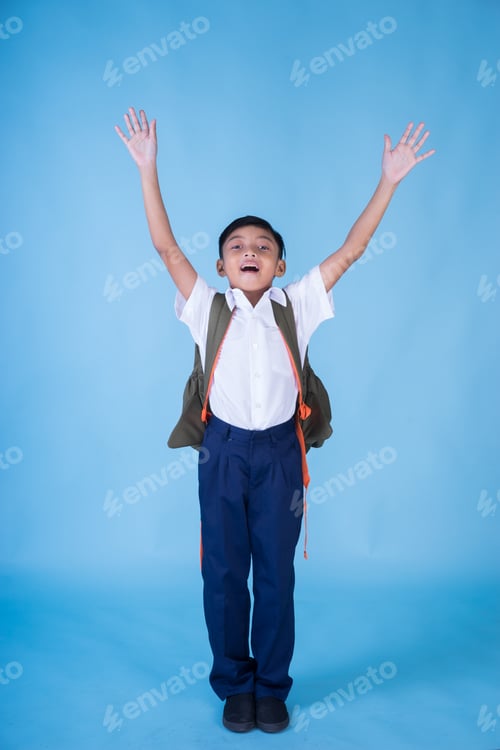 Preview: An Ecstatic Asian School Boy Wearing White Shirt And Blue Pants And Backpack Over Blue Background