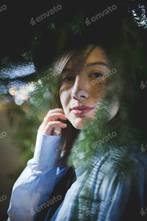 Preview: A Vertical Shot Of A Young Caucasian Female Posing Near Tree Branches