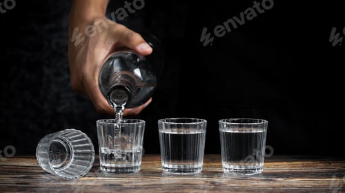 Preview: A Barman Pouring Tequila Into Four Shots