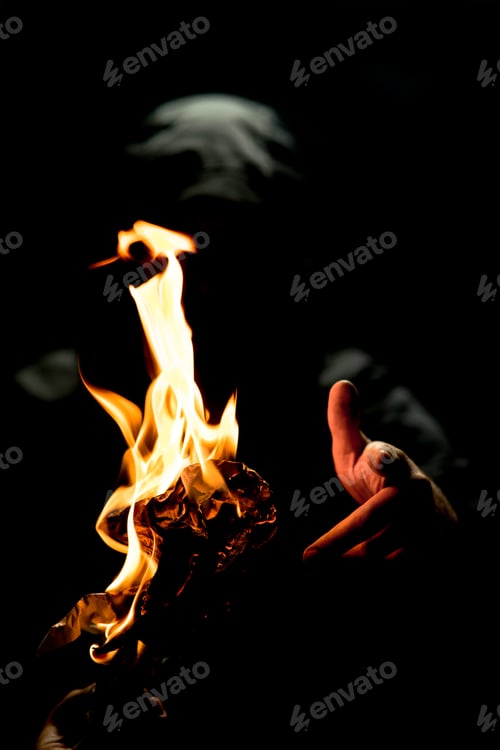 Preview: A Vertical Shot Of A Person Holding A Fire Torch In The Dark