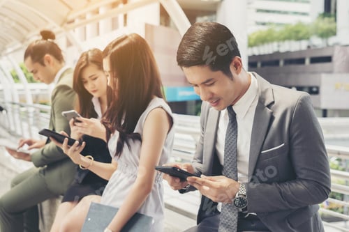 Preview: Business People Using Smartphone While Together