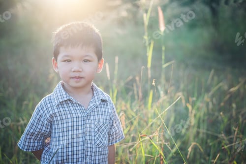 Preview: Happy Little Asian Boy Playing Outdoors. Enjoy Life. Cute Asian Boy On Field.