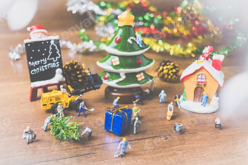 Preview: Creative Concept With Miniature People Creating Christmas Decorations On A Wooden Background
