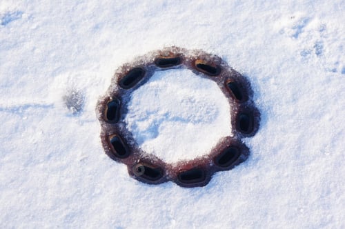 Preview: A High Angle Shot Of A Drain On The Snowy Ground