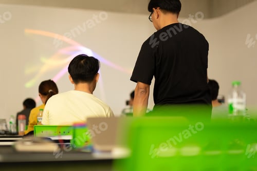 Preview: Back View Of Teacher Explaining To Students In A Class.