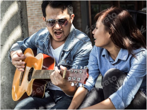 Preview: Hipster Couple Sitting Relaxed With Nice Atmosphere With First Date Enjoys Playing Guitar As A