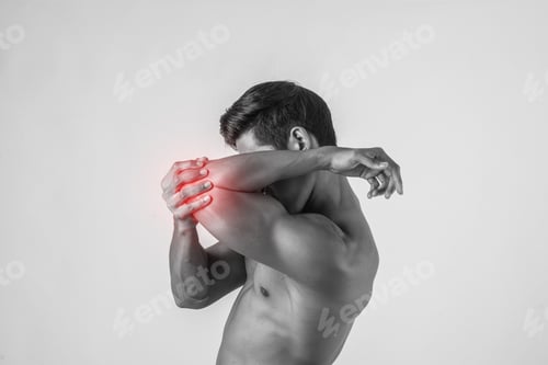 Preview: Portrait Of A Muscle Man Having Elbow Pain Isolated On White Background