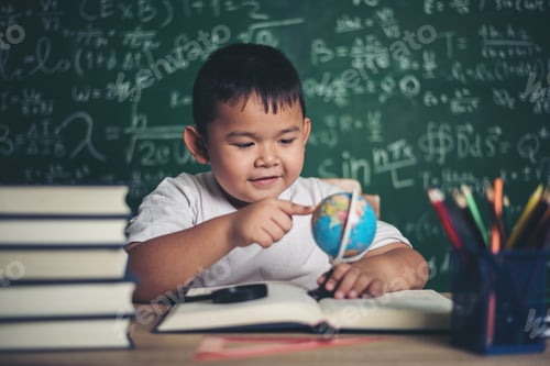 Preview: Kid Observing Or Studying Educational Globe Model In The Classroom.