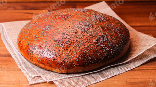 Preview: A Closeup Of Freshly Baked Organic Bread Topped With Poppy Seeds