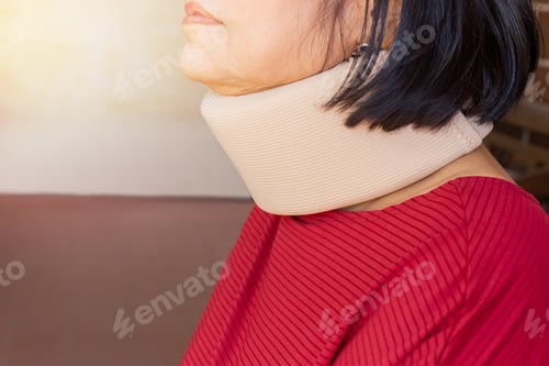 Preview: Asian Senior Woman Wearing Cervical Collar For Neck Injury.