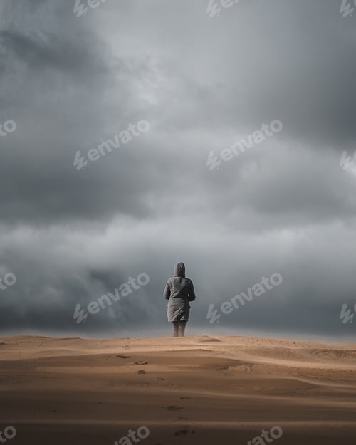 Preview: A Back View Of A Male On The Sandy Beach On A Dark Day