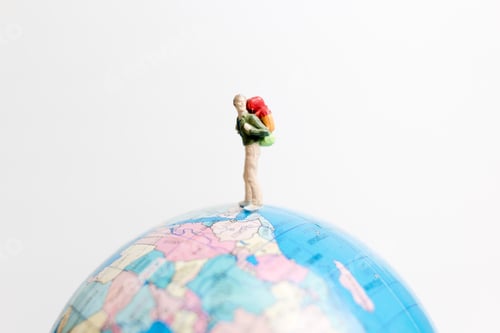 Preview: Miniature People Figure Standing On The Globe World Map With White Background And Copy Space As