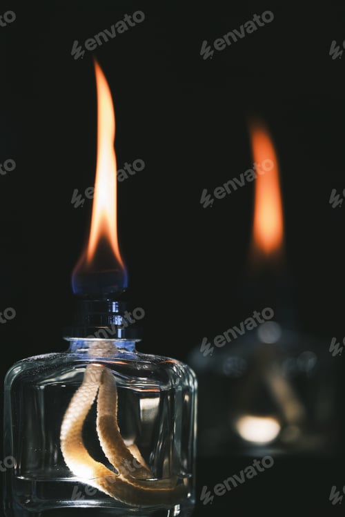 Preview: A Vertical Selective Focus Shot Of Two Alcohol Lighters Isolated On A Black Background