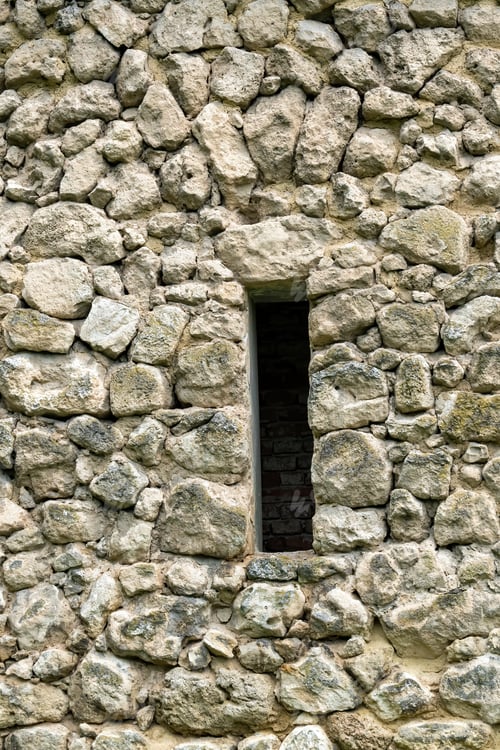Preview: A Vertical Shot Of A Medieval Stone Wall With A Narrow Window - For Backgrounds And Textures